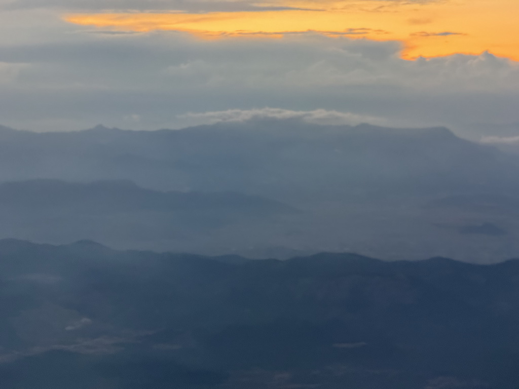 Sunset over the mountains at the north side of the city, viewed from the airplane from Antwerp