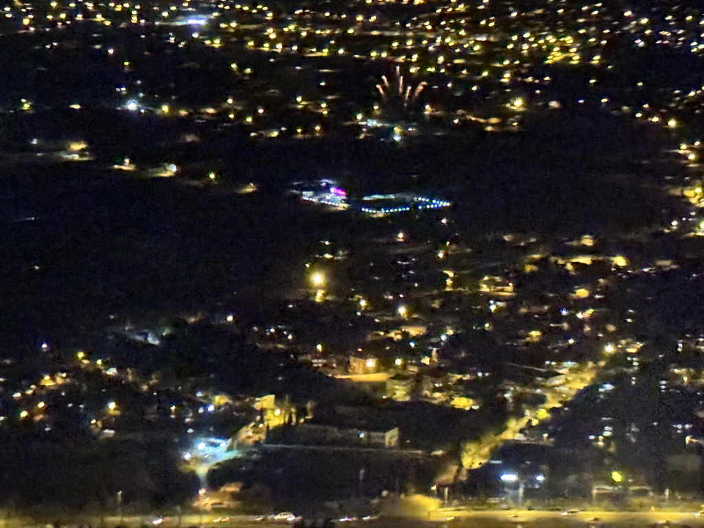 Stadium and fireworks at the northeast side of the city, viewed from the airplane to Antwerp, by night