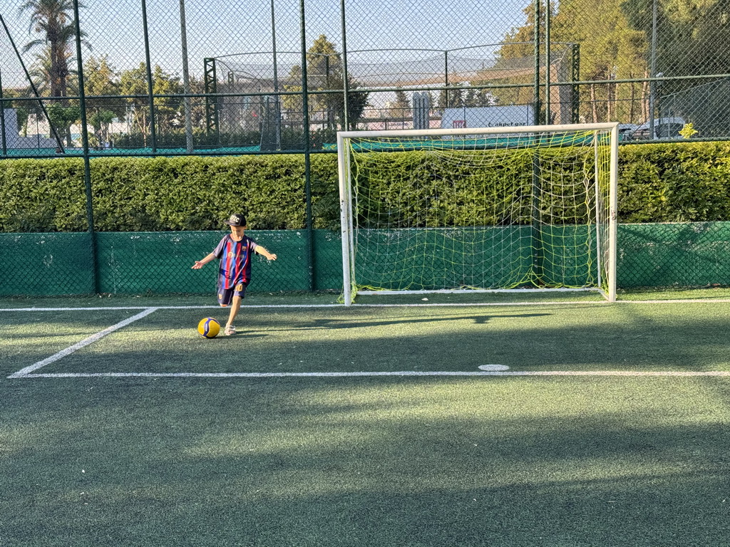 Max playing football at the sports fields at the garden of the Rixos Downtown Antalya hotel