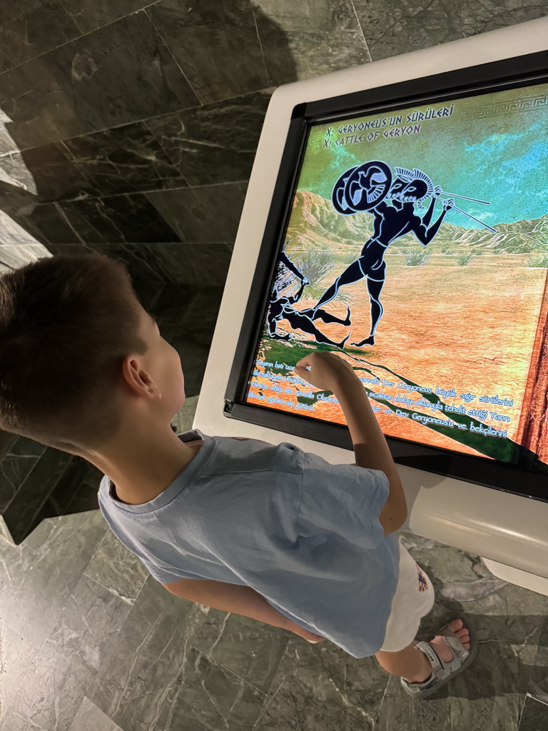 Max playing a game on a screen at the Perge Theater Gallery at the ground floor of the Antalya Archeology Museum