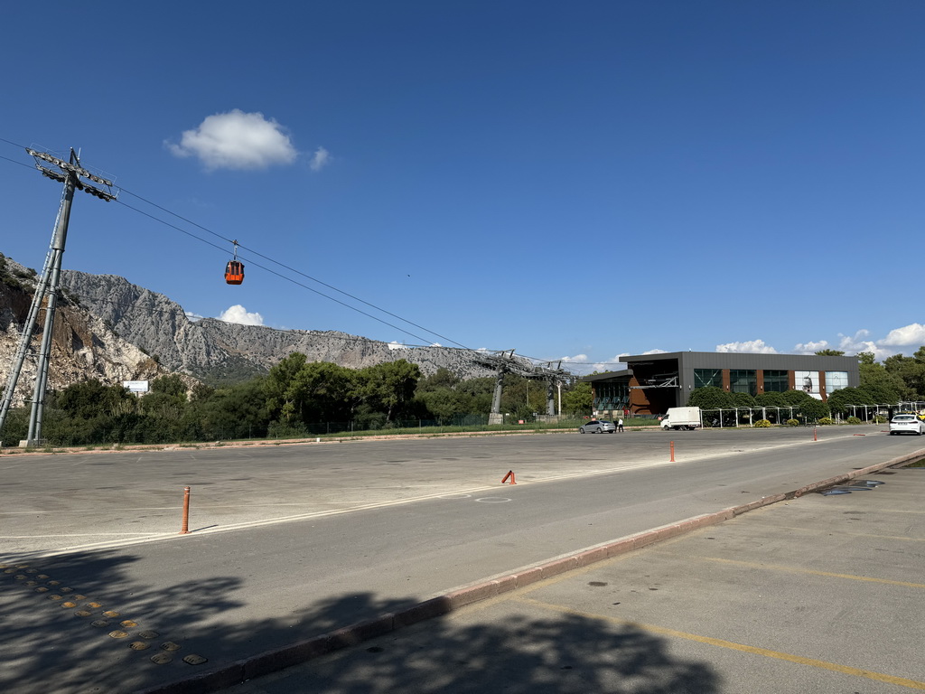 The Tünektepe Teleferik Tesisleri cable car at the Tünek Tepe hill and its lower station, viewed from the parking lot at the Antalya Kemer Yolu road