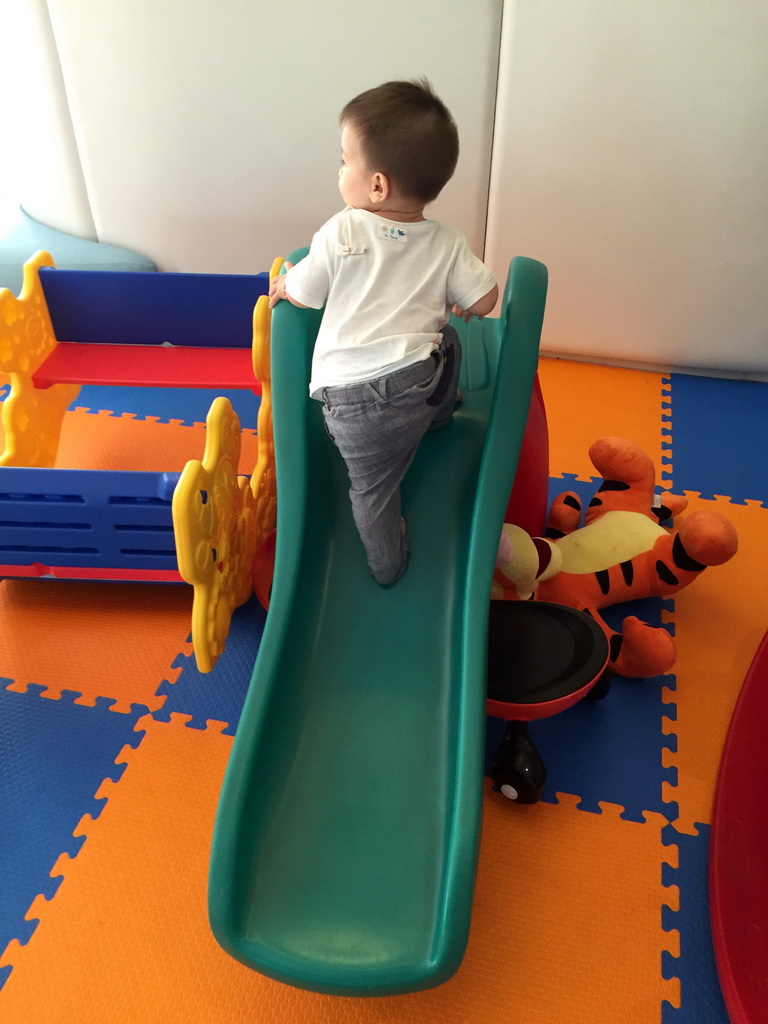 Max on a slide in the Play Room of the Grande Centre Point Hotel Ratchadamri Bangkok