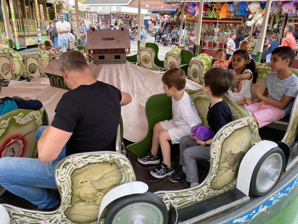 Max and his friend at a carousel at the funfair at the Brigidastraat street