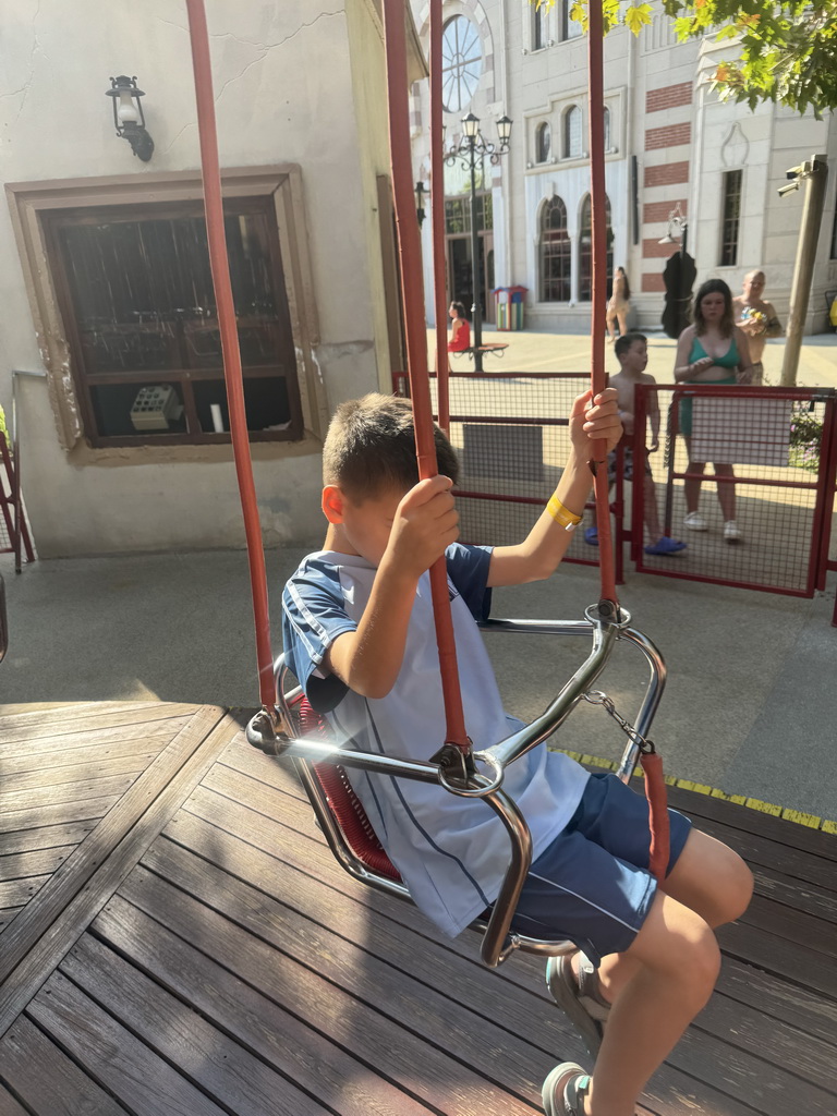 Max at the Family Swing attraction at the Adventure Land area of the Land of Legends theme park, viewed from a swing