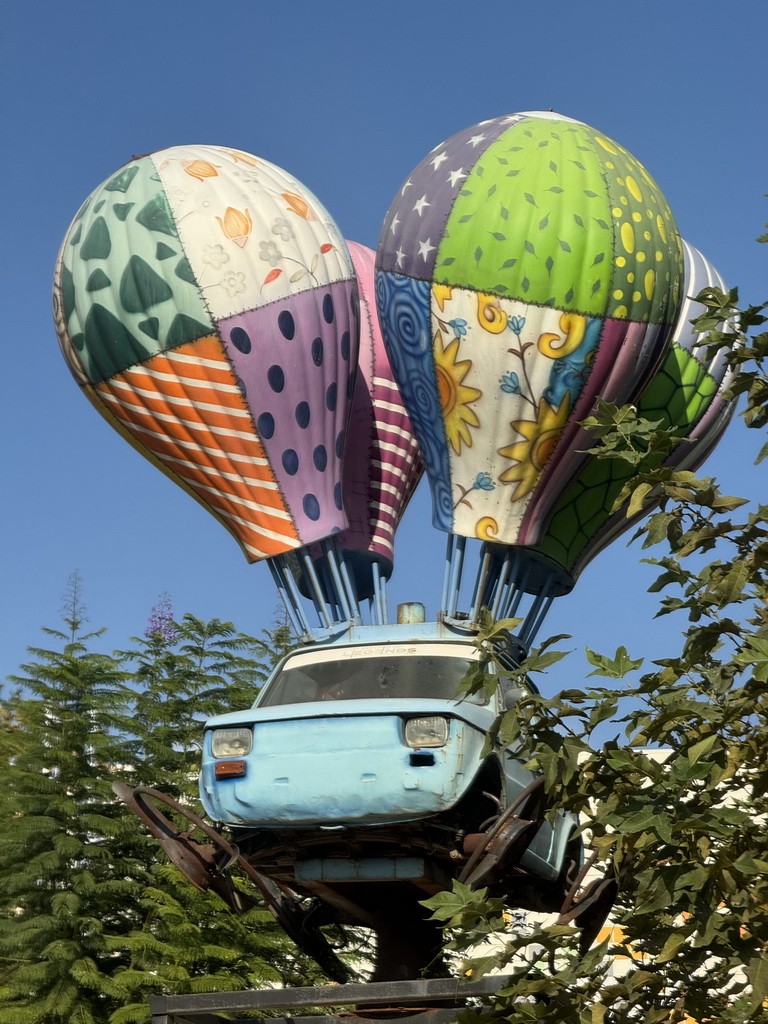 Statue of a car hanging on balloons at the Adventure Land area of the Land of Legends theme park