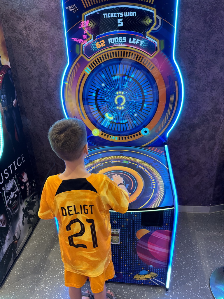 Max playing a game at the Arcade at the Candy Candy store at the Shopping Avenue area of the Land of Legends theme park