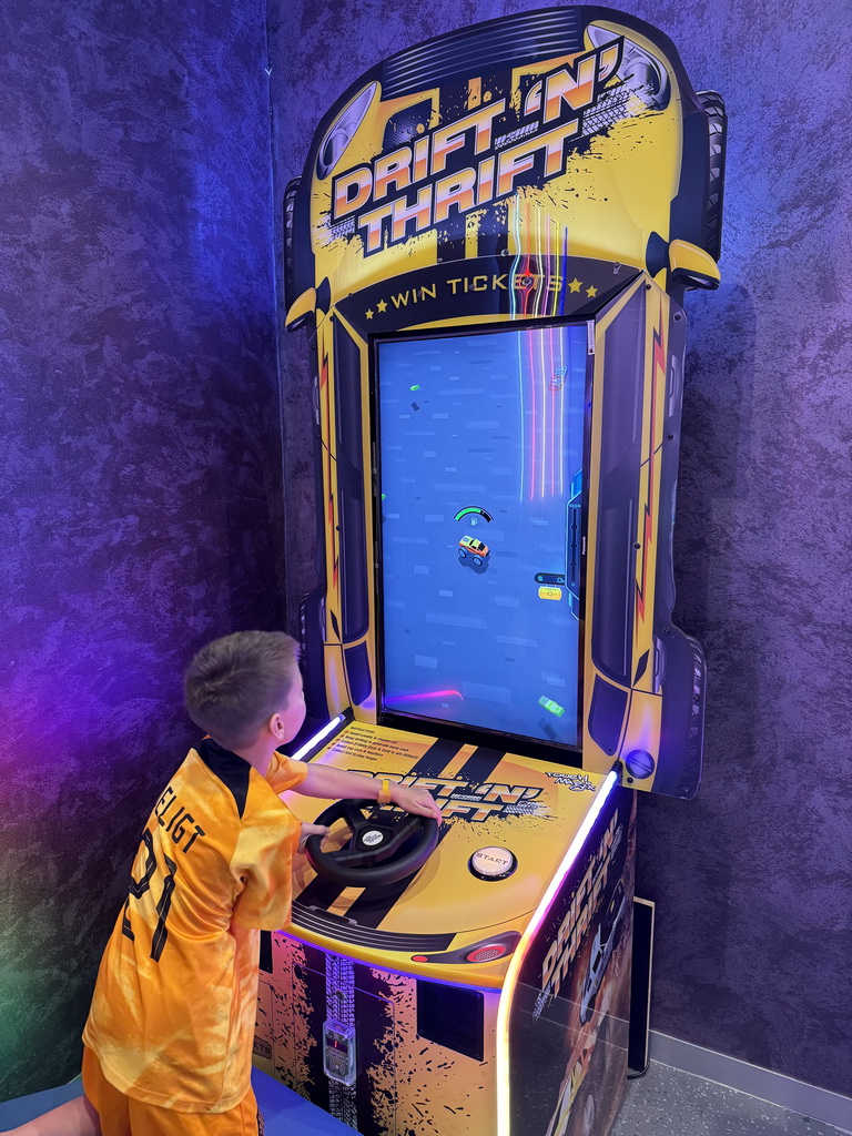 Max playing a game at the Arcade at the Candy Candy store at the Shopping Avenue area of the Land of Legends theme park