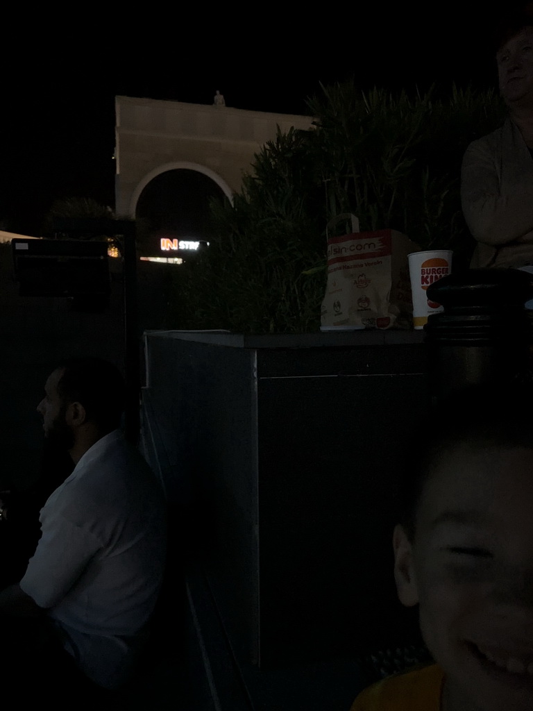 Max in front of the Chateau at the Shopping Avenue area of the Land of Legends theme park, during the Musical Boat Parade, by night