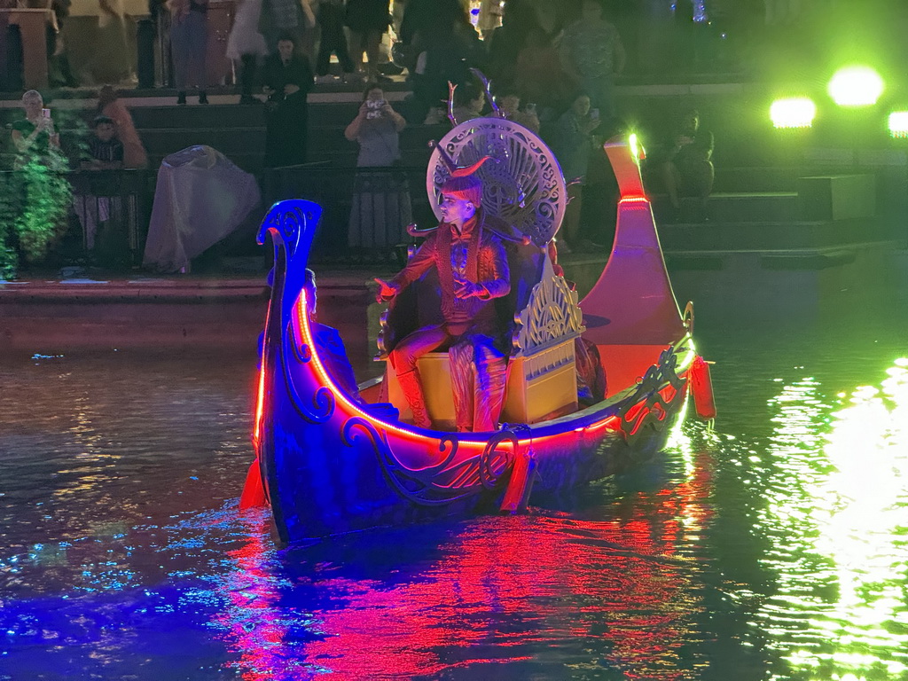 Boat with actors at the canal at the Shopping Avenue area of the Land of Legends theme park, during the Musical Boat Parade, by night