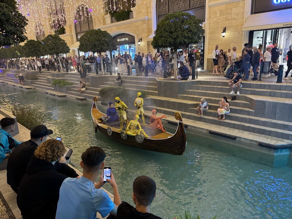 Boat with actors at the canal at the Shopping Avenue area of the Land of Legends theme park, during the Musical Boat Parade, by night