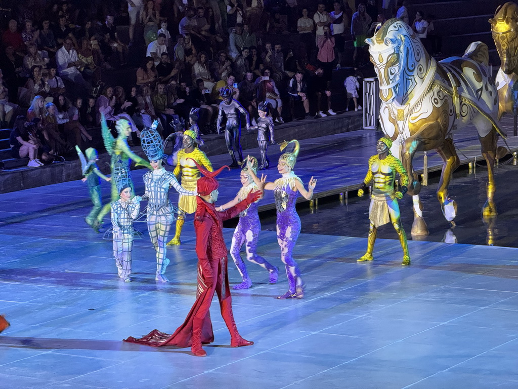 Actors and horse statues in front of the Chateau at the Shopping Avenue area of the Land of Legends theme park, during the Musical Boat Parade, by night