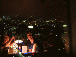 West side of the city, viewed from the Telecafé restaurant on top of the Fernsehturm tower, with a reflection of Tim and Miaomiao having dinner, by night