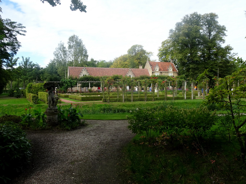 Statue at the English Garden of Bouvigne Castle, with a view on the French Garden and the Koetshuis and Poortgebouw buildings