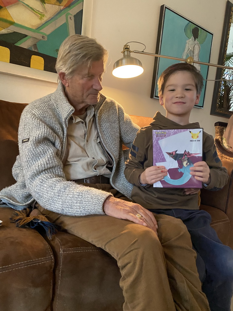 Max and his grandfather with Pokémon cards at his grandfather`s home