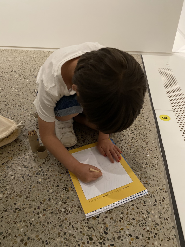 Max drawing in the book with scavenger hunt at the Family of Man exhibition at Clervaux Castle