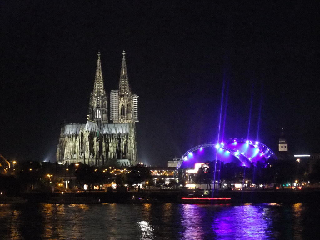 The Rhein river, the Cologne Cathedral, the Musical Dome Köln and the tower of the Basilica church of St. Ursula, viewed from the Kennedy-Ufer street, by night