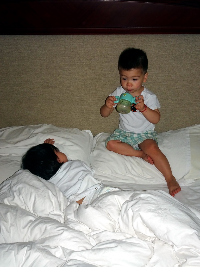 Max and his cousin in our first bedroom at the New Sea View International Hotel