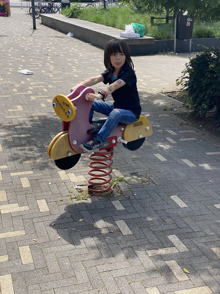 Max on a spring rocker at the parking lot at the Copernicusstraat street