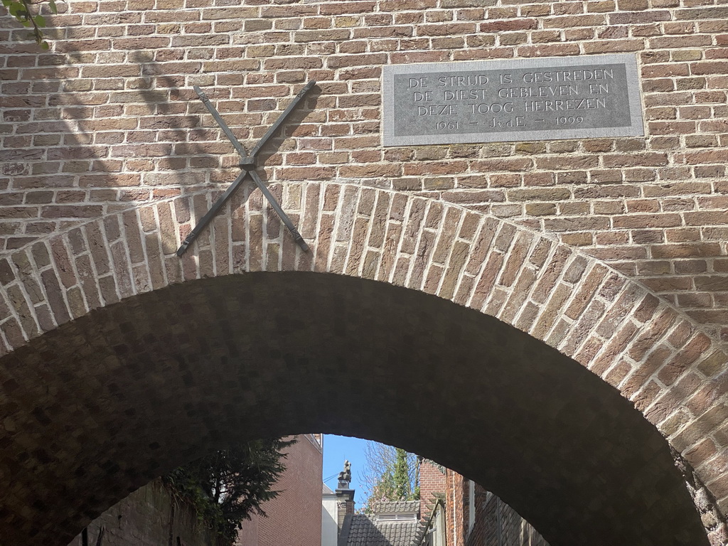 Sign on a building over the Binnendieze canal at the Beurdsestraat street, viewed from the tour boat