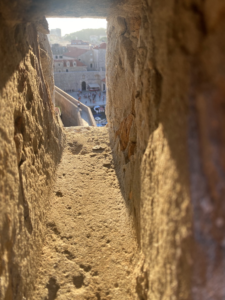 Window at the top of the Tvrdava Svetog Ivana fortress, with a view on the Old Port with the gate to the Poljana Marina Drica street