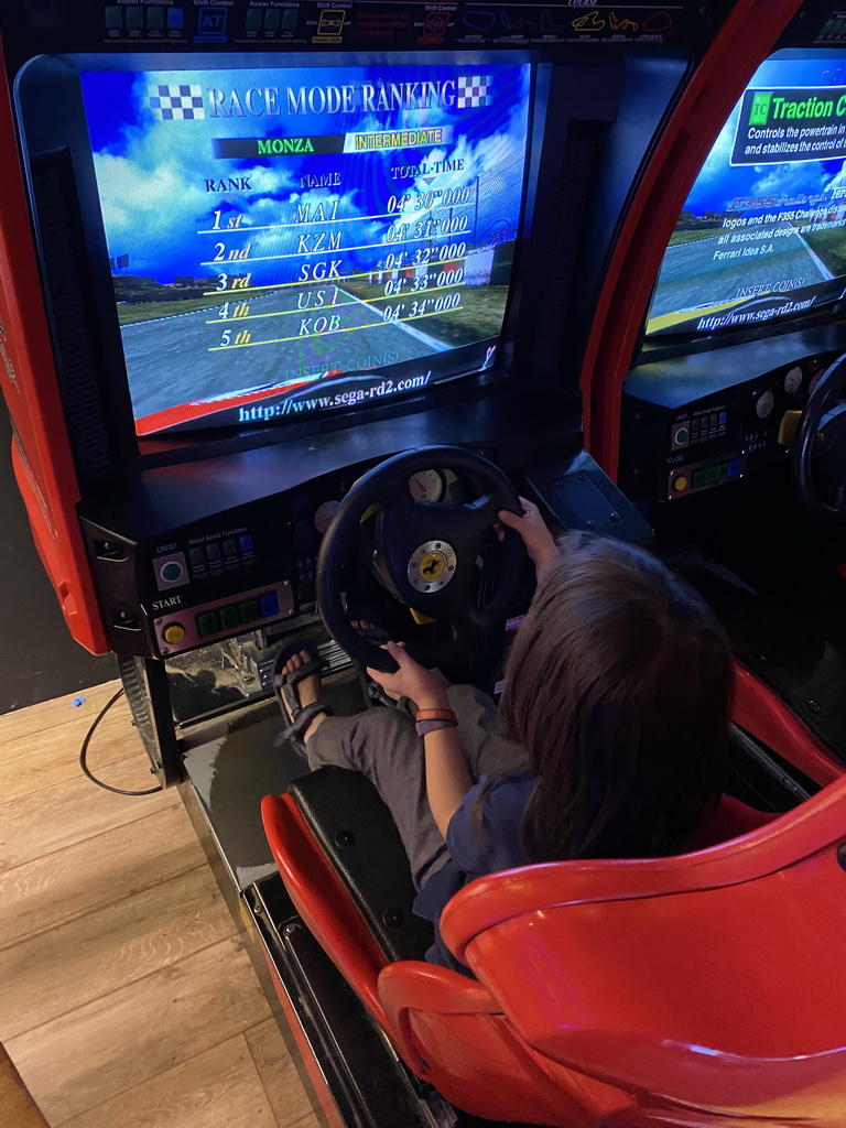 Max playing a racing game at the indoor playground at the Landal Coldenhove holiday park