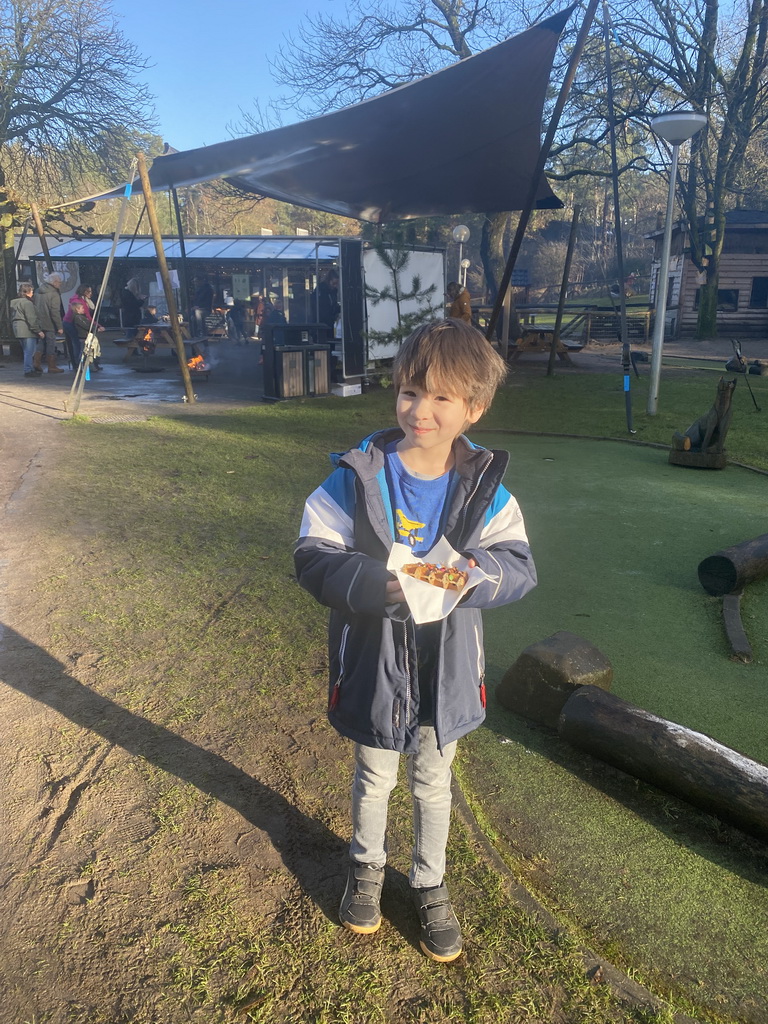 Max with his waffle in front of the campfire at the Landal Coldenhove holiday park