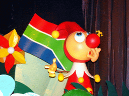 Jokie with a South-African flag at the African scene at the Carnaval Festival attraction at the Reizenrijk kingdom