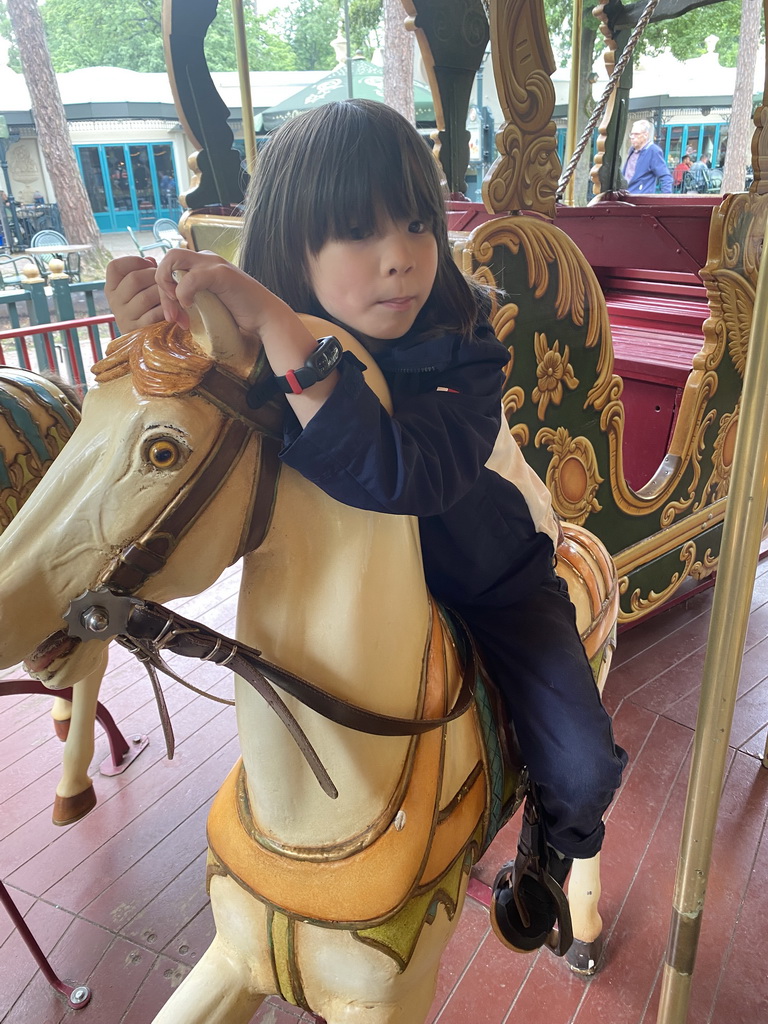 Max on a horse statue at the Vermolen Carousel at the Anton Pieck Plein square at the Marerijk kingdom