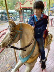 Max on a horse statue at the Vermolen Carousel at the Anton Pieck Plein square at the Marerijk kingdom