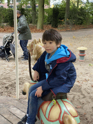 Max on a carousel at the Kindervreugd playground at the Marerijk kingdom