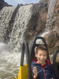 Max in our boat and waterfall at the Piraña attraction at the Anderrijk kingdom