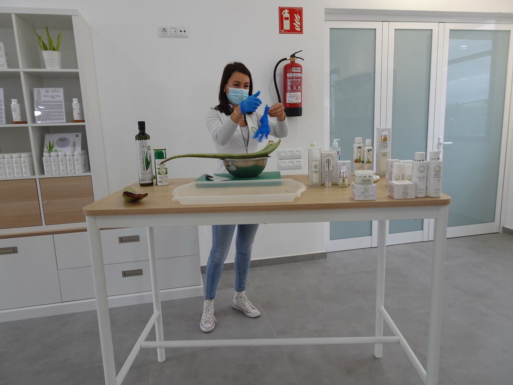 Employee explaining about Aloe Vera at the main building of the Aloe Vera farm