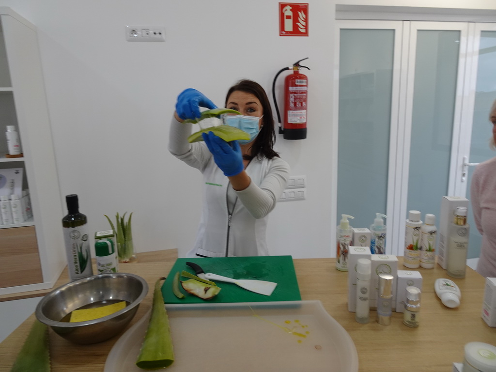 Employee showing Aloe Vera juice at the main building of the Aloe Vera farm