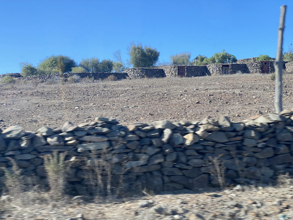 Ancient houses at the Mundo Aborigen theme park, viewed from the tour bus on the GC-60 road