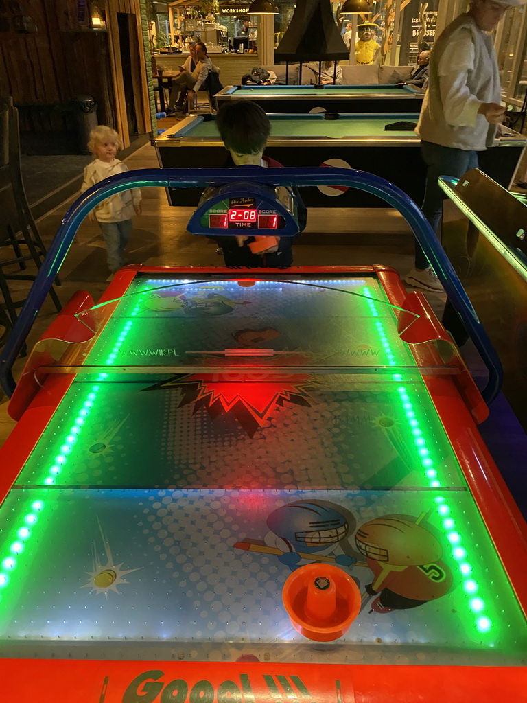 Max playing air hockey at the game room at the Landal Miggelenberg holiday park