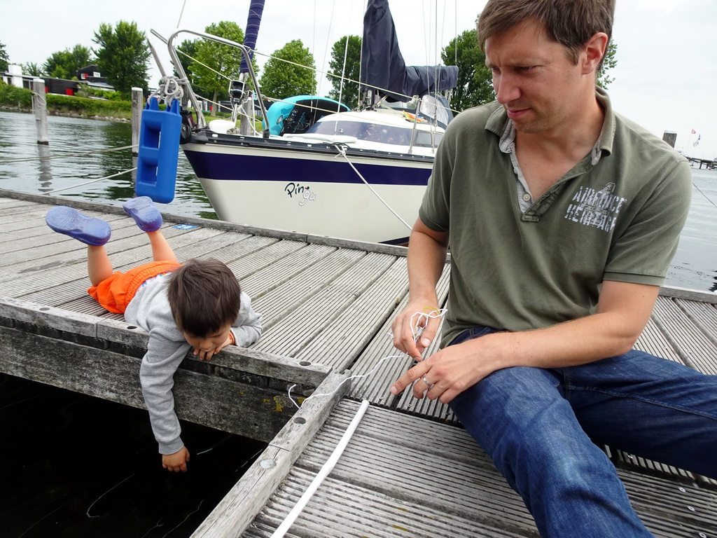 Tim and Max catching crabs on a pier at Camping and Villa Park De Paardekreek