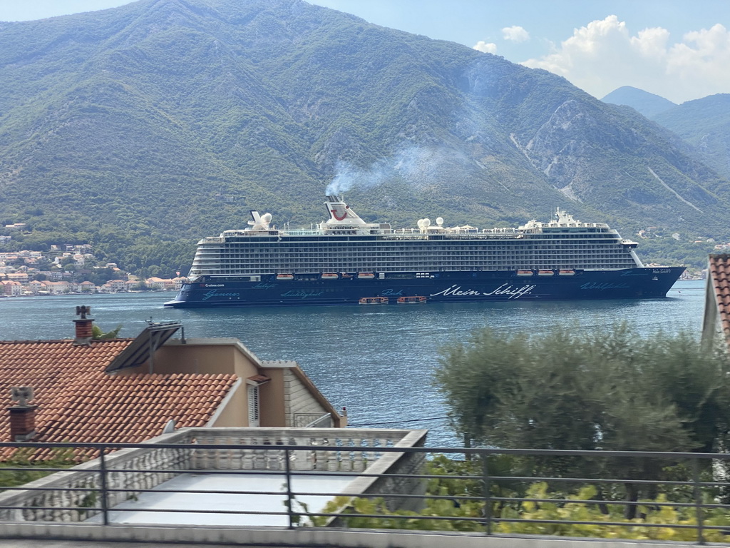 Cruise ship `Mein Schiff` at the bay of Kotor, viewed from the tour bus on the E65 road at the town of Dobrota