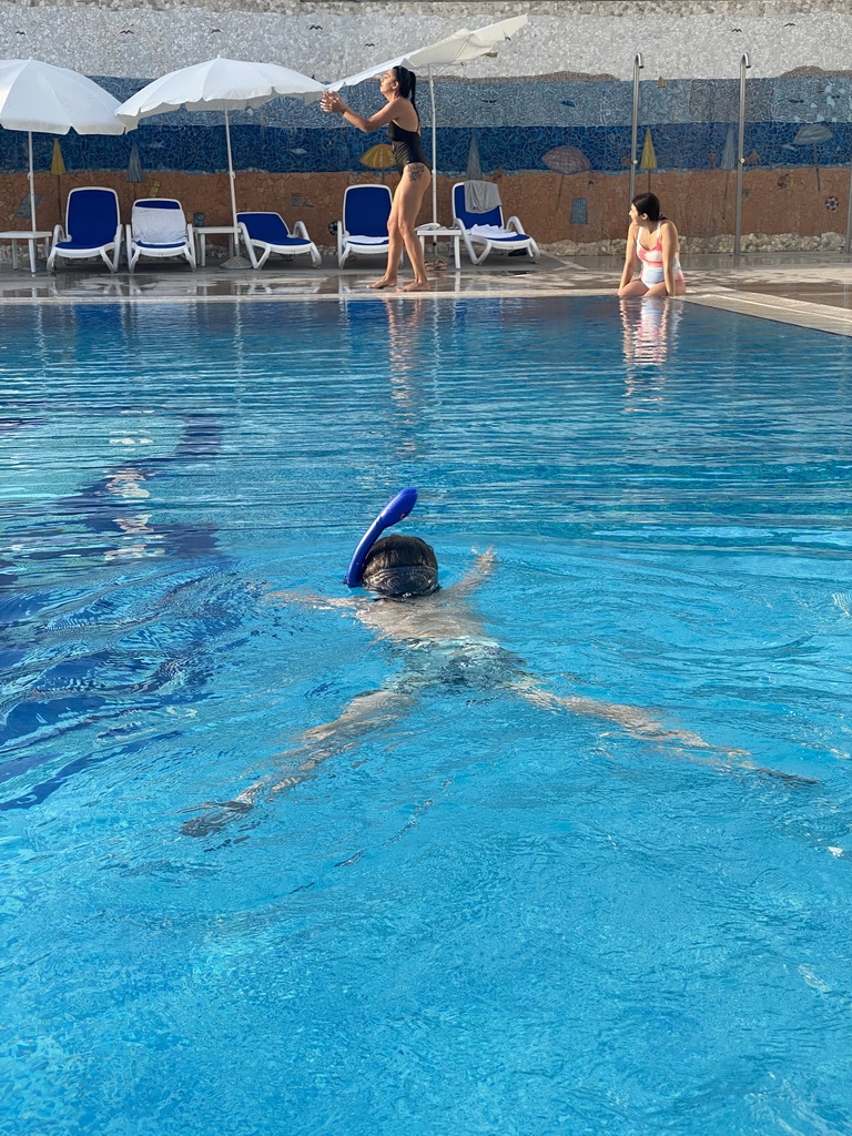 Max with goggles and snorkel at the outdoor swimming pool of the Grand Hotel Park