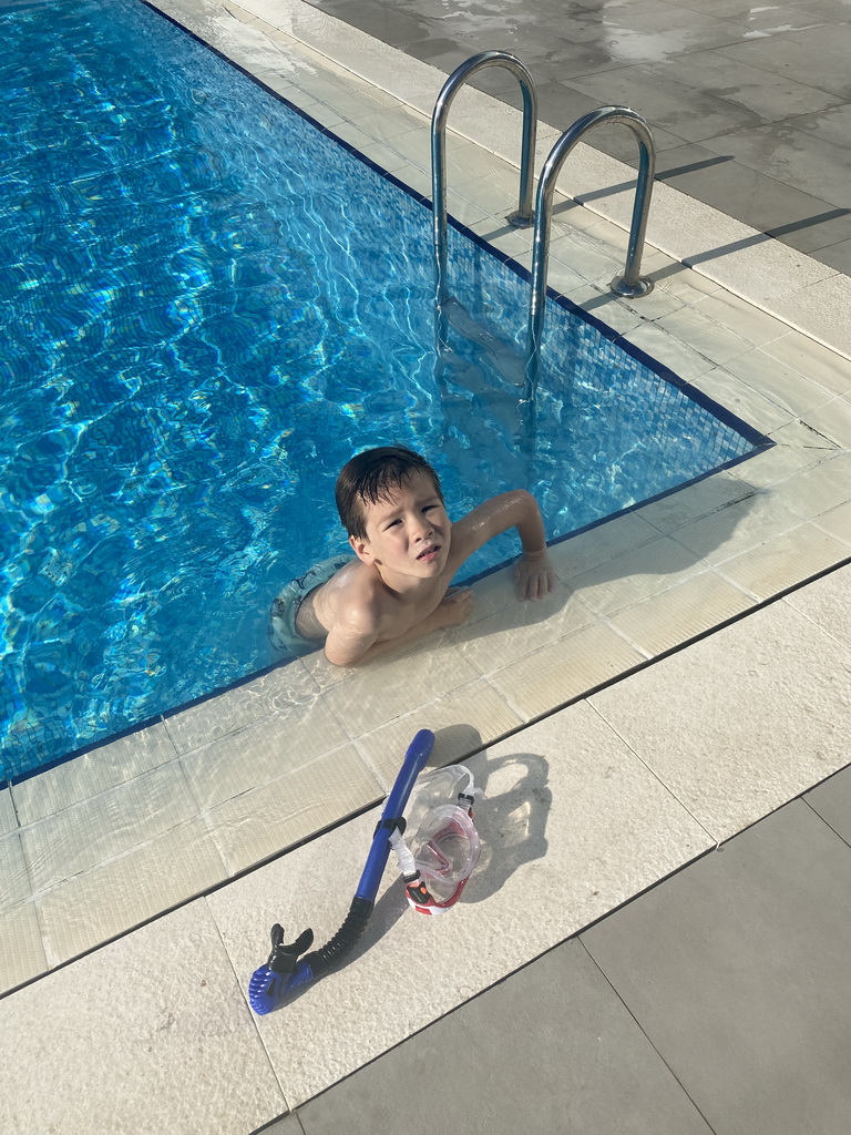 Max with goggles and snorkel at the outdoor swimming pool of the Grand Hotel Park