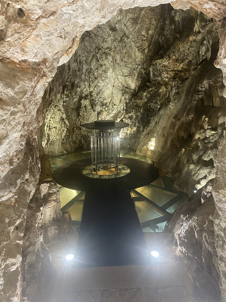 Table and glass floor at the small cave at the Cave Bar More