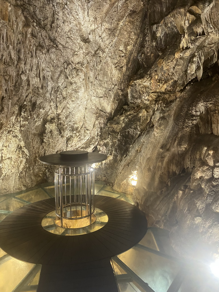 Table and glass floor at the small cave at the Cave Bar More