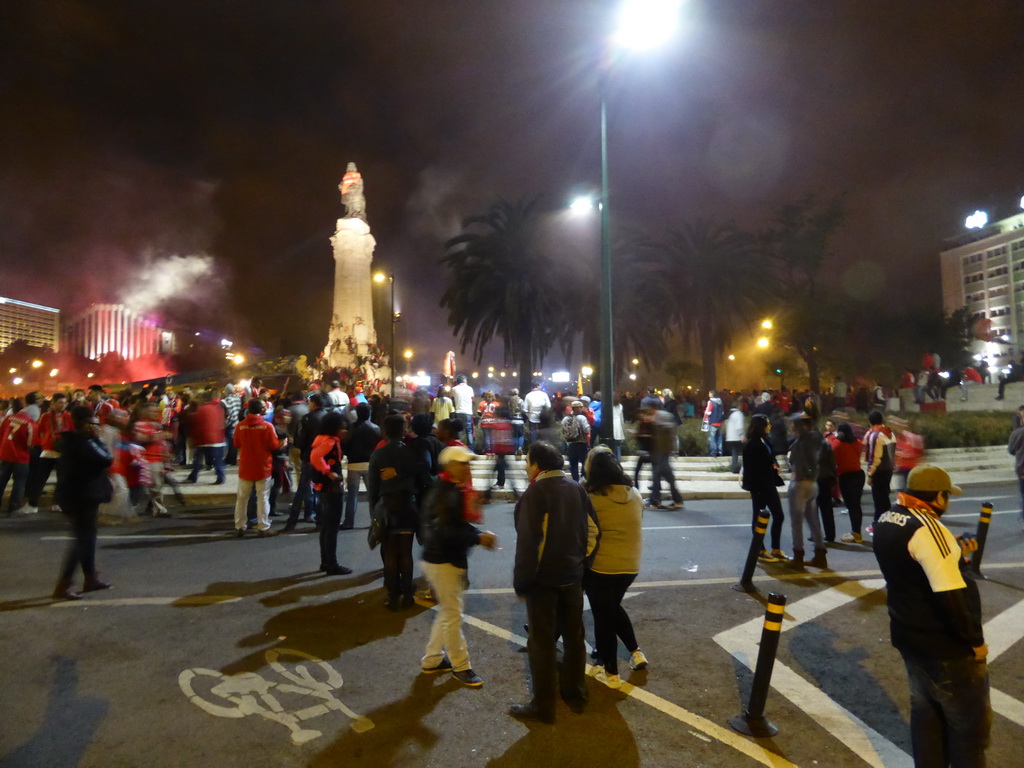 Fans of the S.L. Benfica soccer team celebrating the championship and the statue of the Marquess of Pombal at the Praça do Marquês de Pombal square, by night