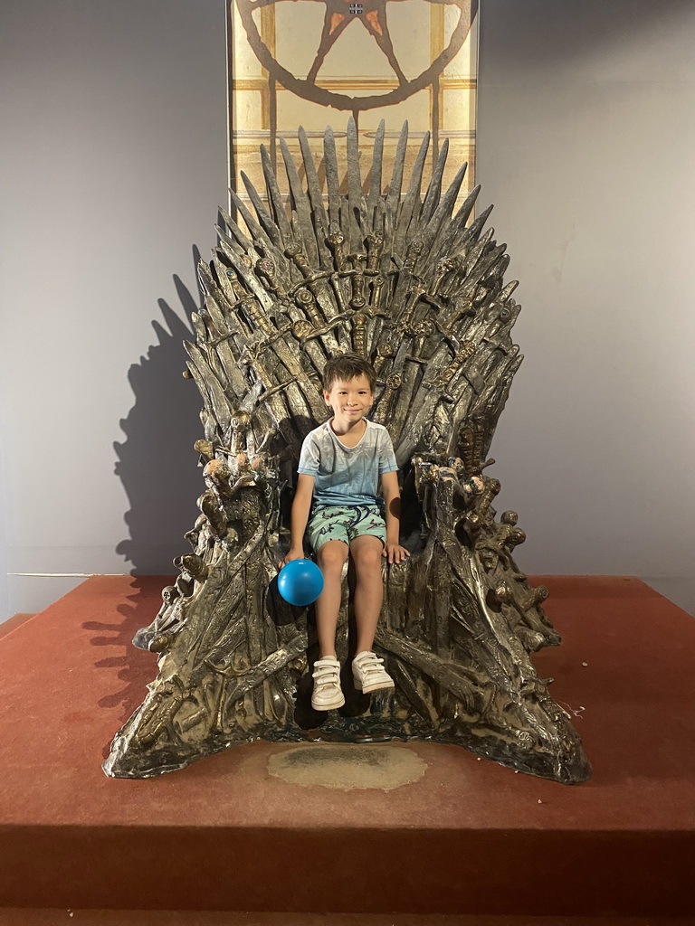 Max with a balloon on the Iron Throne from Game of Thrones at the Game of Thrones exhibition at the Lokrum Visitor Center at the southeast side of the Benedictine Monastery of St. Mary