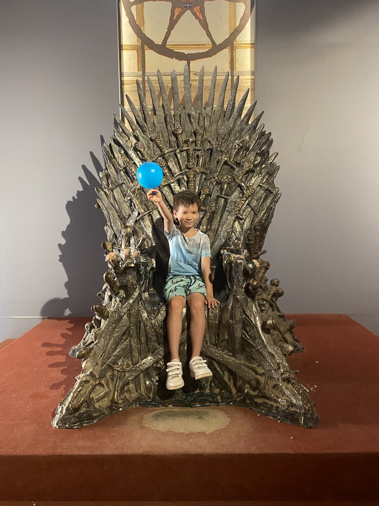 Max with a balloon on the Iron Throne from Game of Thrones at the Game of Thrones exhibition at the Lokrum Visitor Center at the southeast side of the Benedictine Monastery of St. Mary