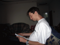 Tim reading in the living room of Miaomiao`s grandparents` house