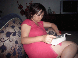 Miaomiao reading in the living room of Miaomiao`s grandparents` house