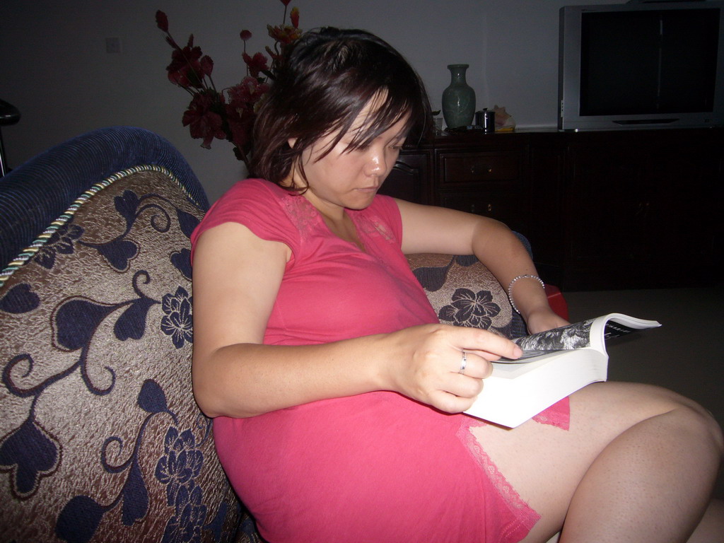 Miaomiao reading in the living room of Miaomiao`s grandparents` house