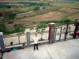 Tim in front of Miaomiao`s grandparents` house, viewed from the roof