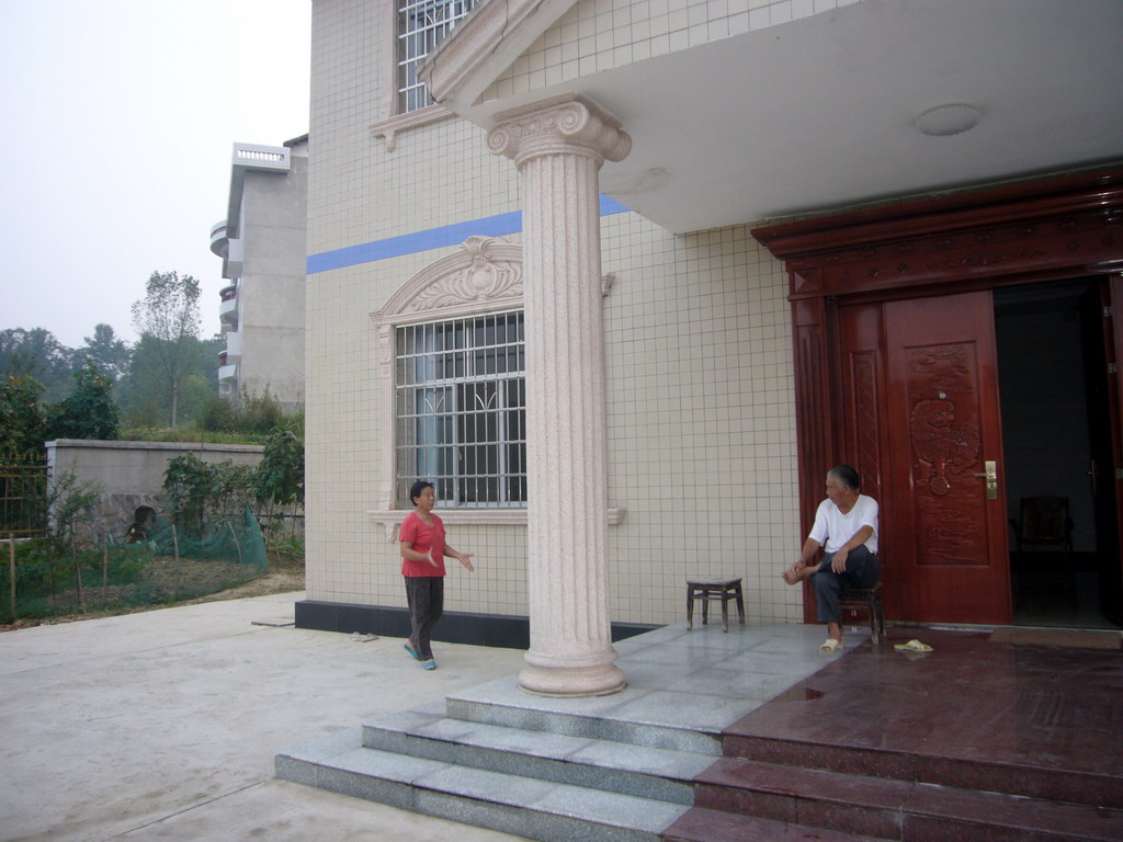 Miaomiao`s grandparents in front of their house