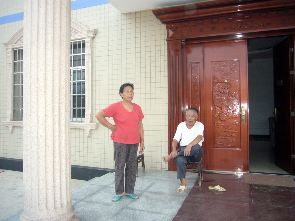 Miaomiao`s grandparents in front of their house